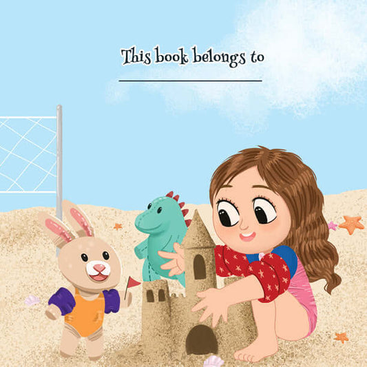 Nika building sandcastles with stuffed animals on the beach in "Nika Loves The Beach" children's book.